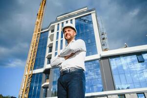 A construction worker control in the construction of roof structures on construction site and sunset background photo