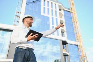 A construction worker control in the construction of roof structures on construction site and sunset background photo
