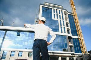 Industrial theme constructor standing at a site area. photo