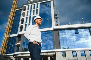 A construction worker control in the construction of roof structures on construction site and sunset background photo