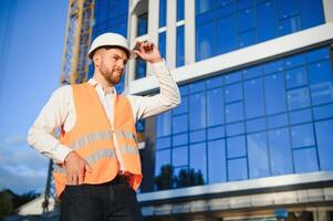 construction worker or architect in construction site outdoors with Hot weather sunny . builder in hard hat inspecting and working in workplace photo
