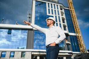 A construction worker control in the construction of roof structures on construction site and sunset background photo
