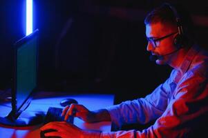 Handsome young male software developer programming codes while working from home photo