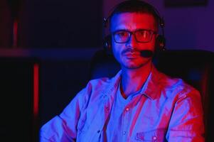 young man playing computer games on line photo