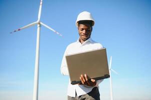 Engineer African man standing with wind turbine photo