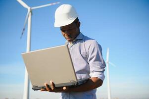 Engineers are investigating the wind turbine. photo