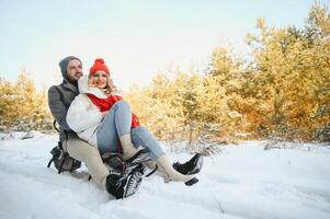 Two young people sliding on a sled photo