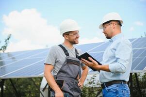 engineer and businessman planing new ecology project. around solar panel photo