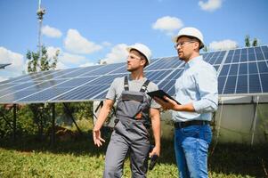 engineer and businessman planing new ecology project. around solar panel photo