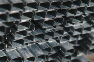 Stack of rolled metal products, perspective view of steel pipes of rectangular cross-section photo
