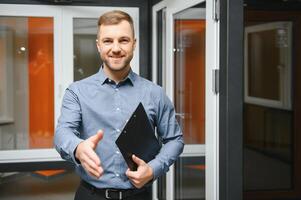 Friendly seller in window shop with keys. A large selection of windows and doors for the house. Home renovation concep photo