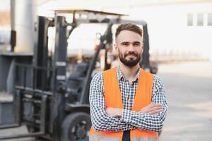 Waving forklift driver in the warehouse of a haulage company while driving forklift photo