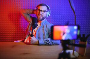 A blogger records content in his studio. The backstage photo was taken from behind one of the participants in the shooting, at the beginning of the shooting when the blogger is preparing.