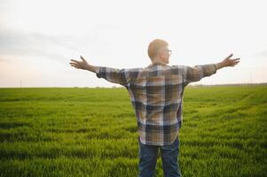 Experienced and confident farmer on his field. Portrait of senior farmer agronomist in wheat field. photo