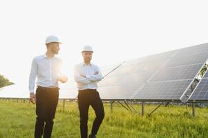 Project manager discuss with worker installation process of solar panel photo