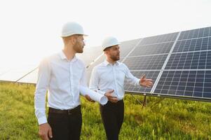 Project manager discuss with worker installation process of solar panel photo