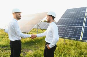 Project manager discuss with worker installation process of solar panel photo