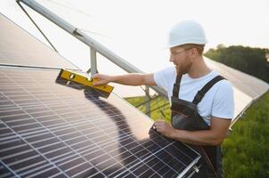 Worker installing solar panels outdoors photo