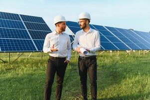 engineer and businessman planing new ecology project. around solar panel roof photo