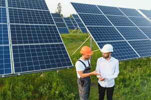 engineer and businessman planing new ecology project. around solar panel roof photo
