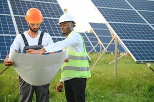 engineer and businessman planing new ecology project. around solar panel roof photo