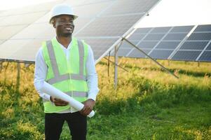 African american technician check the maintenance of the solar panels. Black man engineer at solar station. photo