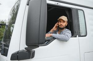 Truck driver sitting in cab photo