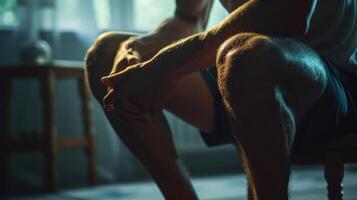 A Man Sitting on a Chair With Legs Crossed in a Dimly Lit Room photo