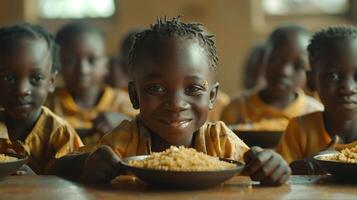 Smiling African Child Eating Meal in Classroom photo