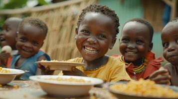 Happy Children Enjoying a Meal Together in Africa photo