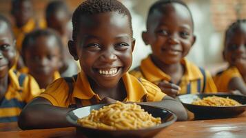 A Young Boy Smiles While Enjoying a Meal With Other Children at a School in Africa photo