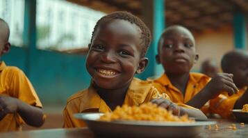 Smiling Boy Eating Noodles in a School Lunchroom photo