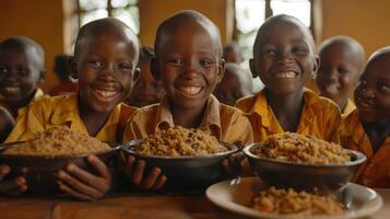 Smiling African Children Enjoying a Meal in a Classroom photo