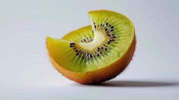 Freshly Cut Kiwi Fruit Displaying Vibrant Green Flesh and Black Seeds on White Background. photo
