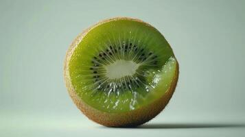 Sliced Kiwi Fruit Revealing Bright Green Flesh and Black Seeds With Fuzzy Brown Skin on White Background. photo