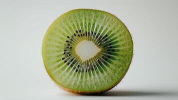 Freshly Sliced Kiwi Fruit Revealing Its Vibrant Green Interior and Black Seeds. photo