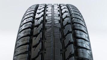 Close-Up Of A Newly Designed Tire Captured In Studio Lighting Revealing Intricate Tread Patterns And Textures Against A Plain Background. photo