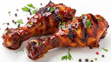 Savory Grilled Chicken Drumsticks Glazed With Sweet BBQ Sauce Garnished With Fresh Herbs on a White Background. photo