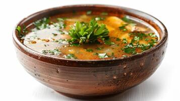 A Warm Bowl of Hearty Chicken Soup Garnished With Fresh Herbs on a Cozy Kitchen Table. photo