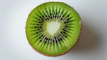 Freshly Cut Kiwi Sliced in Half Revealing Vibrant Green Flesh and Tiny Black Seeds on White Background. photo