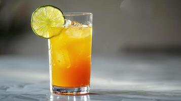 Refreshing Citrus Beverage With Layered Colors Served in a Tall Glass With Ice Cubes. photo