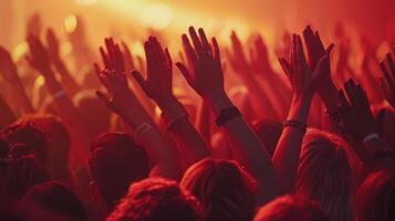 Excited Crowd With Hands Raised in Celebration Under Vibrant Stage Lights at an Evening Concert photo