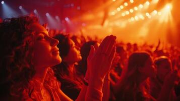 Enthusiastic Crowd Applauding in a Vibrant Concert Atmosphere at Night photo