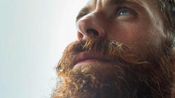 Capturing Introspection and Depth in a Bearded Man's Expression Under Soft Natural Light photo