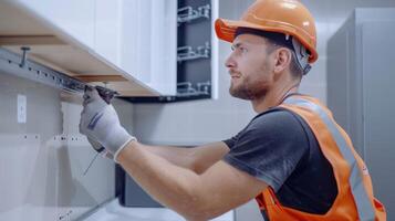 Craftsman Skillfully Installing Cabinets in a Modern Kitchen Renovation During Daylight Hours photo