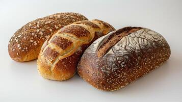 Three Artisanal Bread Loaves Displayed On A Simple White Backdrop In A Bright Kitchen Setting photo