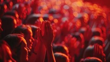Energized Crowd Celebrating an Unforgettable Performance Under Vibrant Red Lights at an Evening Concert photo