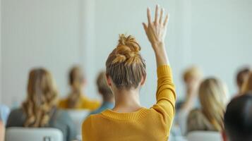 Engaged Woman Raising Hand During Interactive Learning Session in Bright Classroom Setting photo
