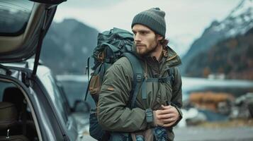 Adventurous Hiker Preparing for Exploration Amid Majestic Mountain Landscape at Dusk photo