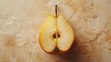 A Perfectly Sliced Yellow Pear Sitting Gracefully on a Textured Beige Background Amid Soft Natural Light photo